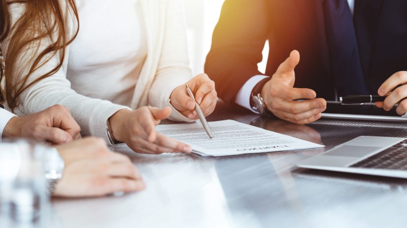 Business team reviewing documents together at a meeting table.