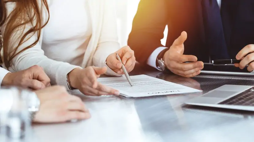 Business team reviewing documents together at a meeting table.