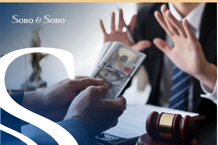 Client preparing to hand hundred dollar bills to an attorney